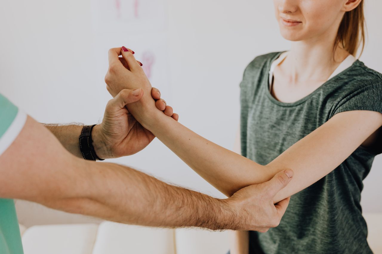 Mastering the First Impression: Your intriguing post title goes here Crop faceless orthopedist in uniform and wristwatch checking up arm joint of slim woman in casual wear in doctor office in clinic