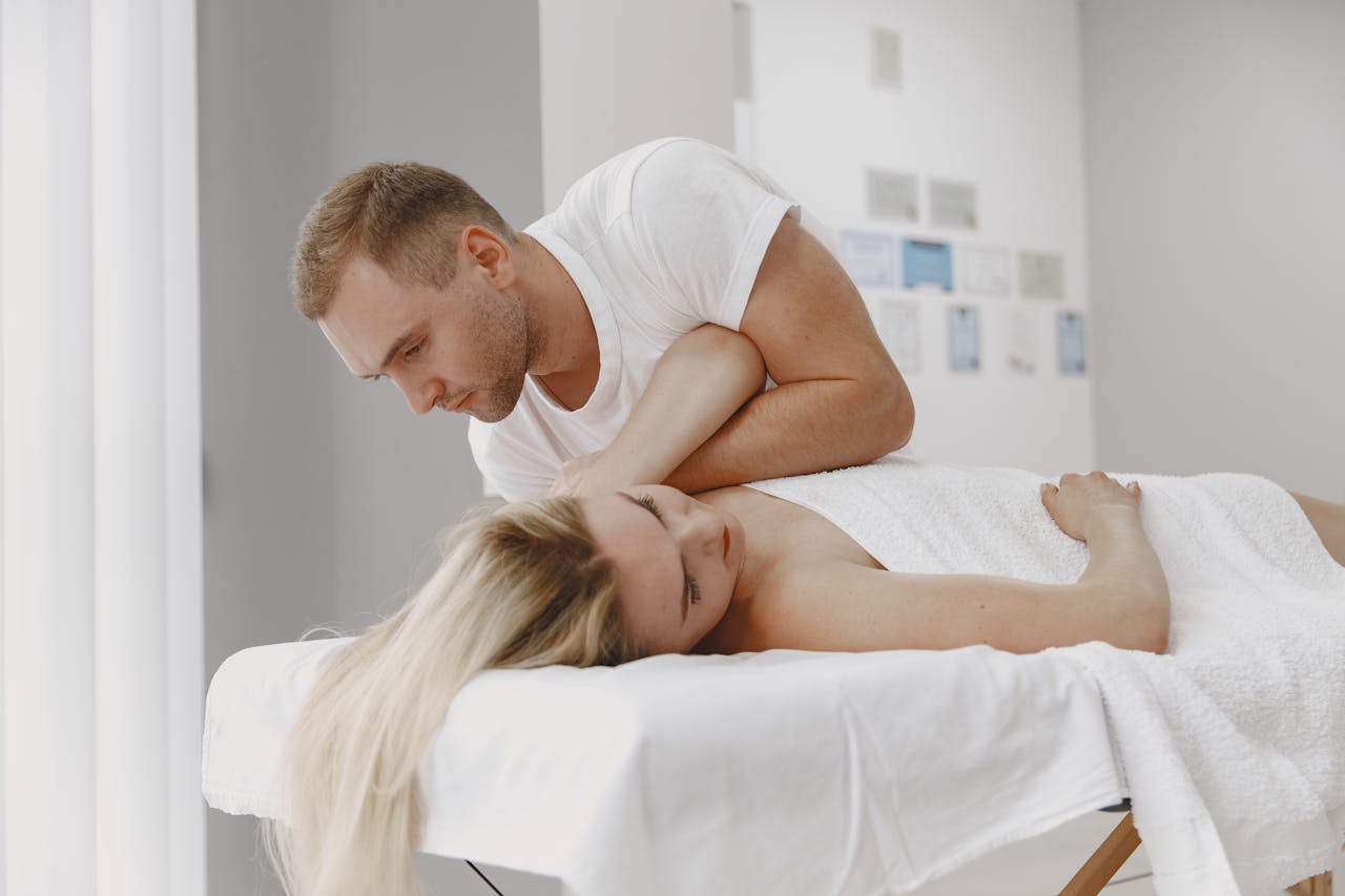 Relaxing massage therapy session in a spa setting, featuring a therapist and a client.